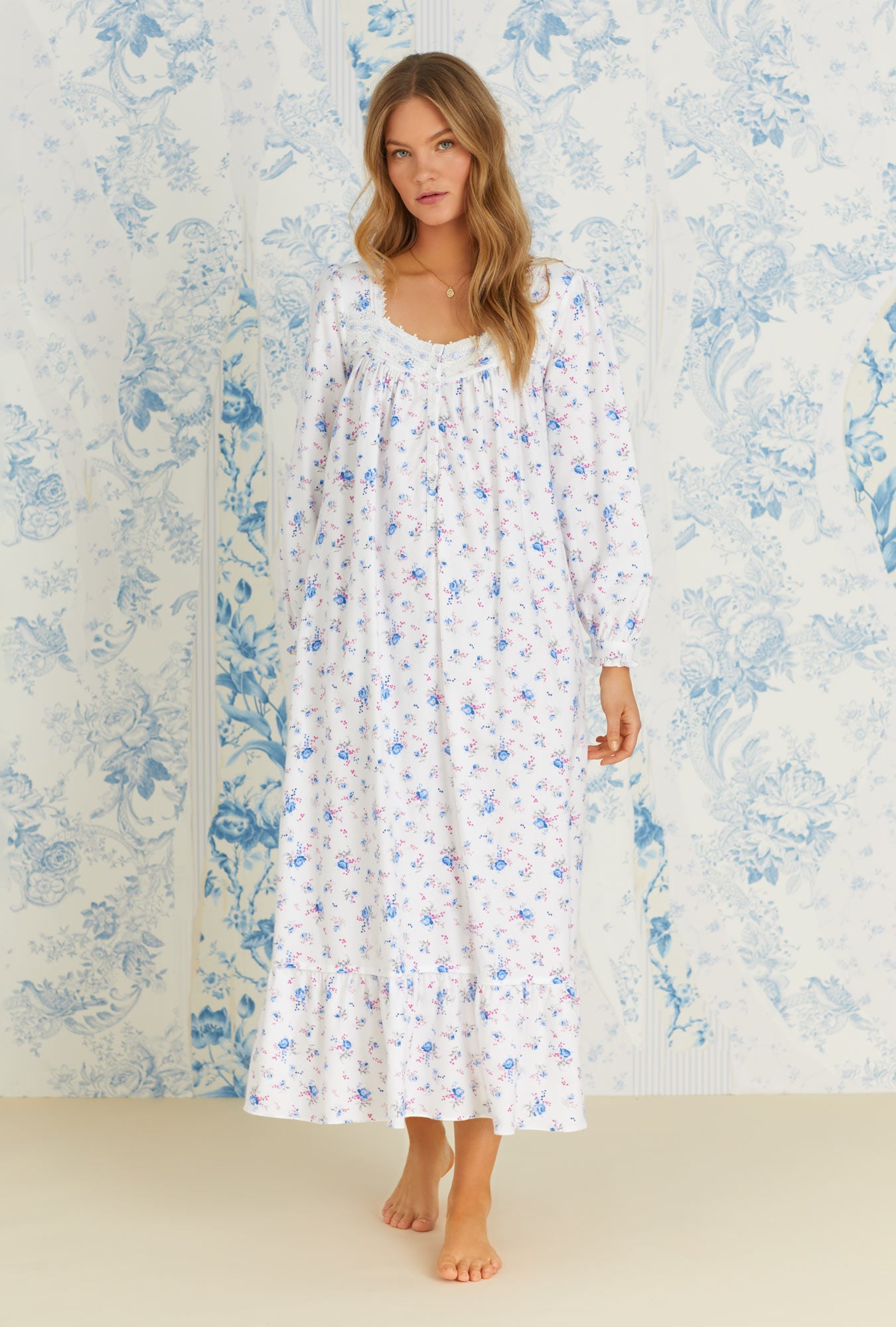 A lady wearing long sleeve rose and berry floral rayon cotton flannel long nightgown.