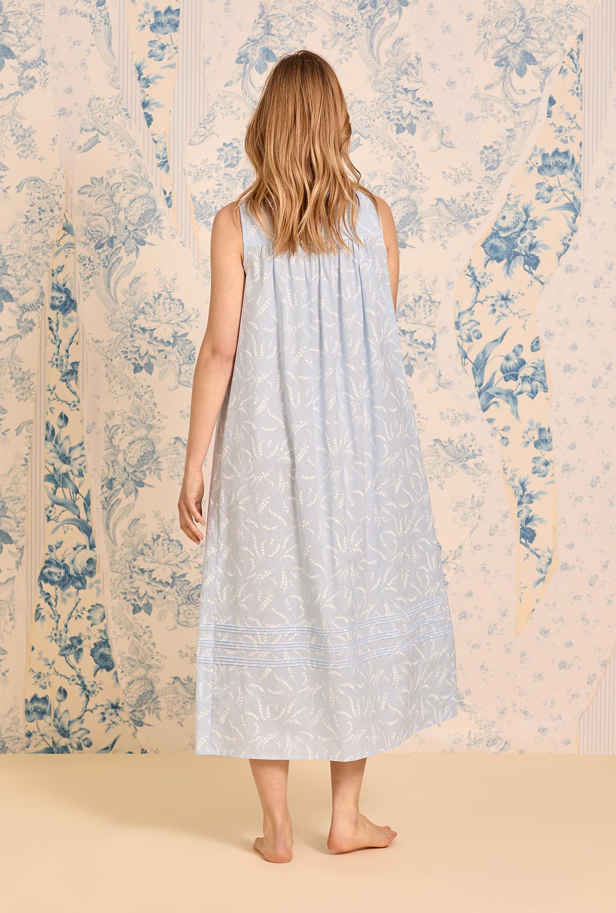 A lady wearing The &quot;Eileen&quot; Moonlit Lily Cotton Lawn Ballet Nightgown