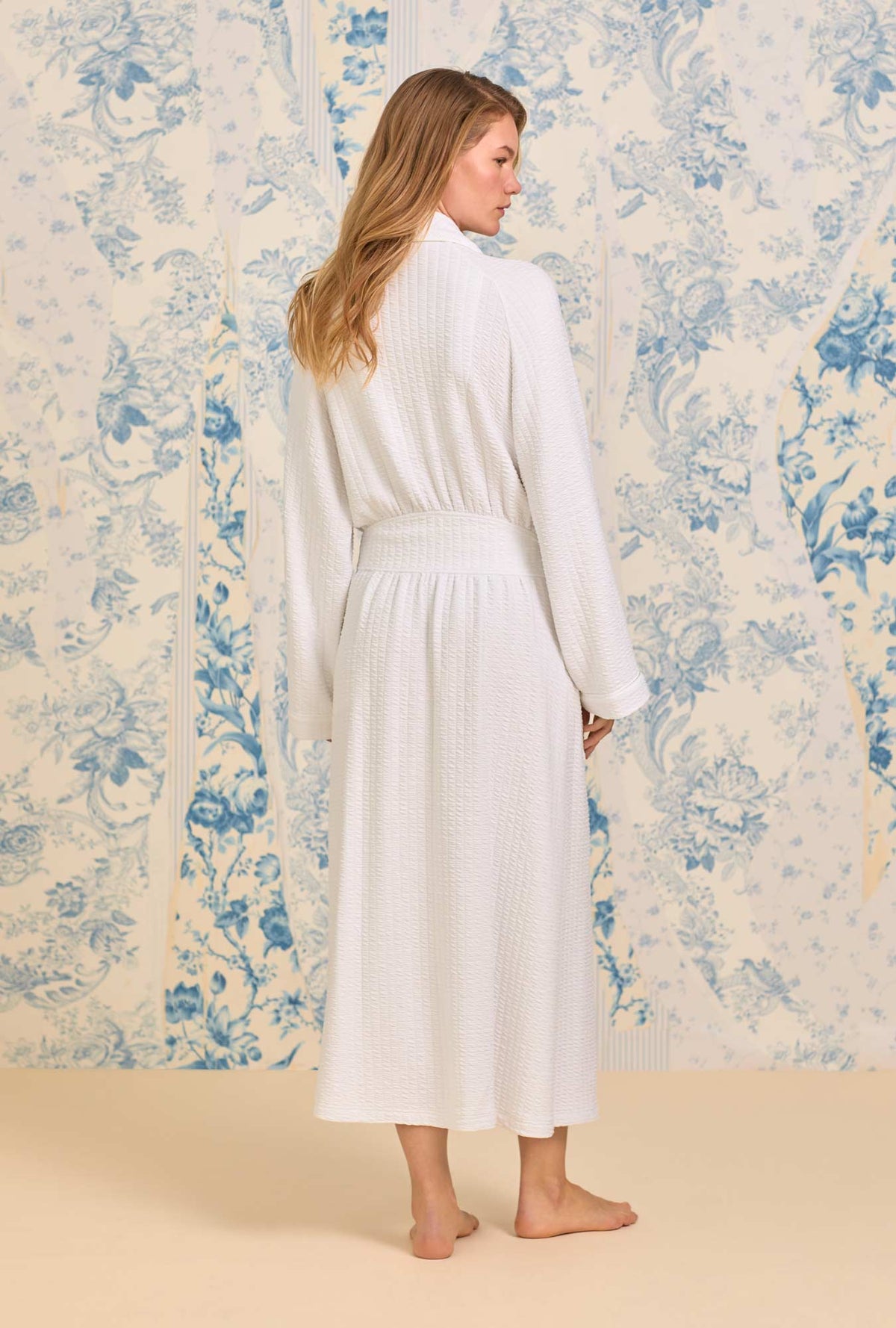 A lady wearing Iconic White Silky Cotton Waffle Knit Long Wrap Robe