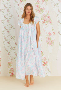 A lady wearing multi color cap sleeve cotton button front robe with monterey bay print.