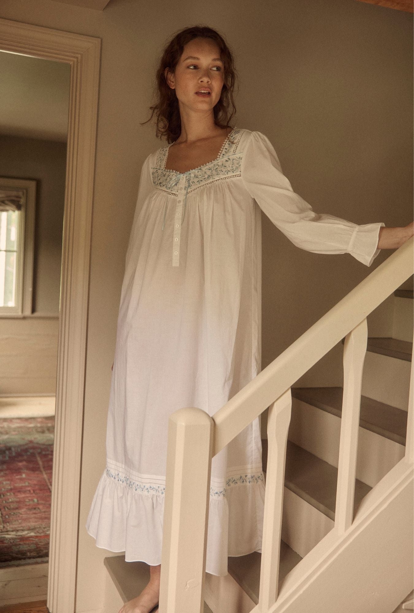 A lady wearing Iconic White Cornflower Embroidery Cotton Lawn Long Sleeve Ballet Nightgown