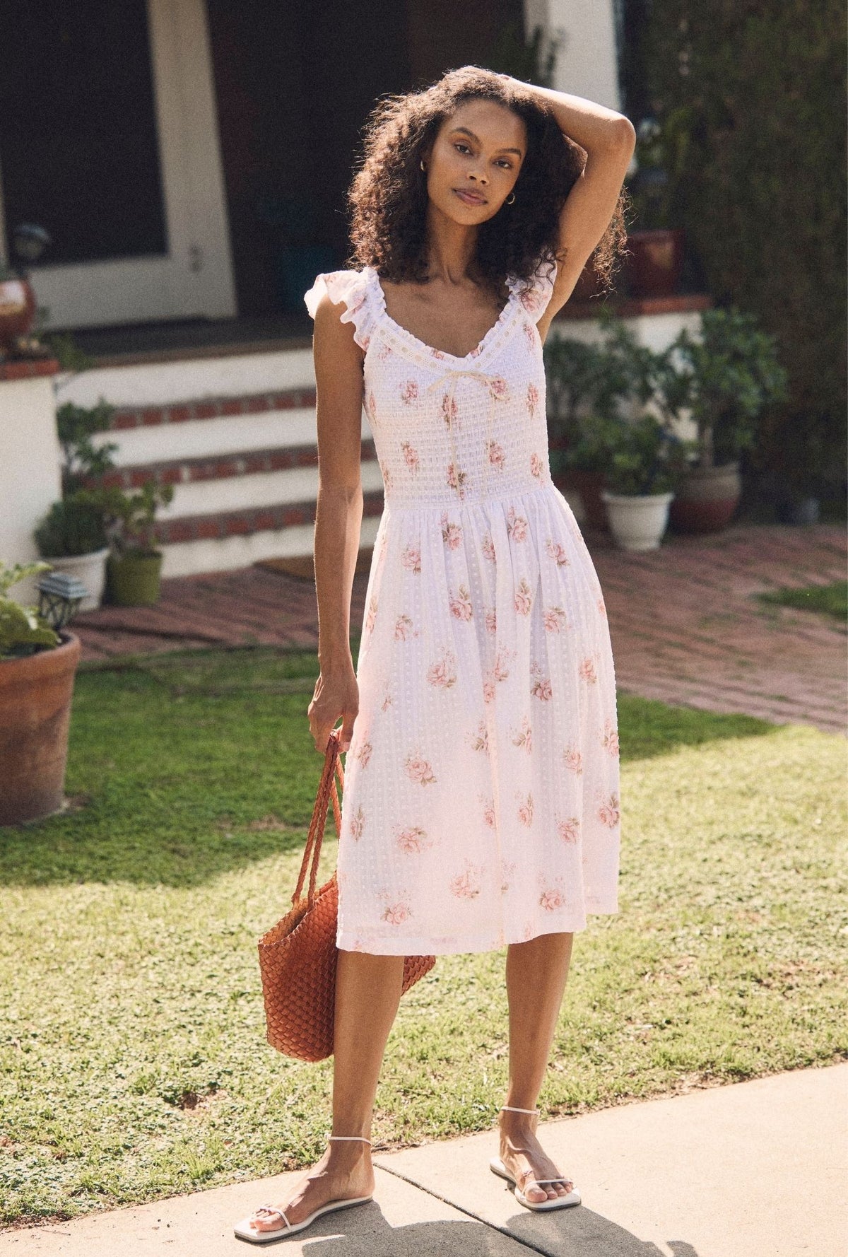 A lady wearing the "Ada" Venice Rose Cotton Swiss Dot Midi Dress