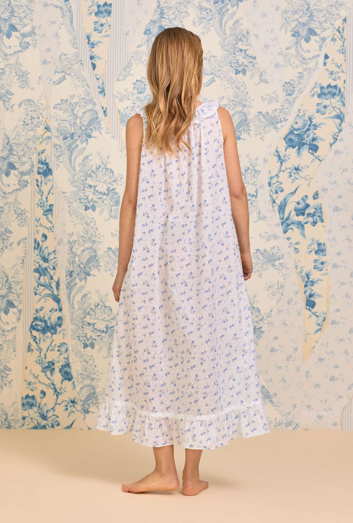 A lady wearing The &quot;Elizabeth&quot; Navy Floral Swiss Dot Long Nightgown