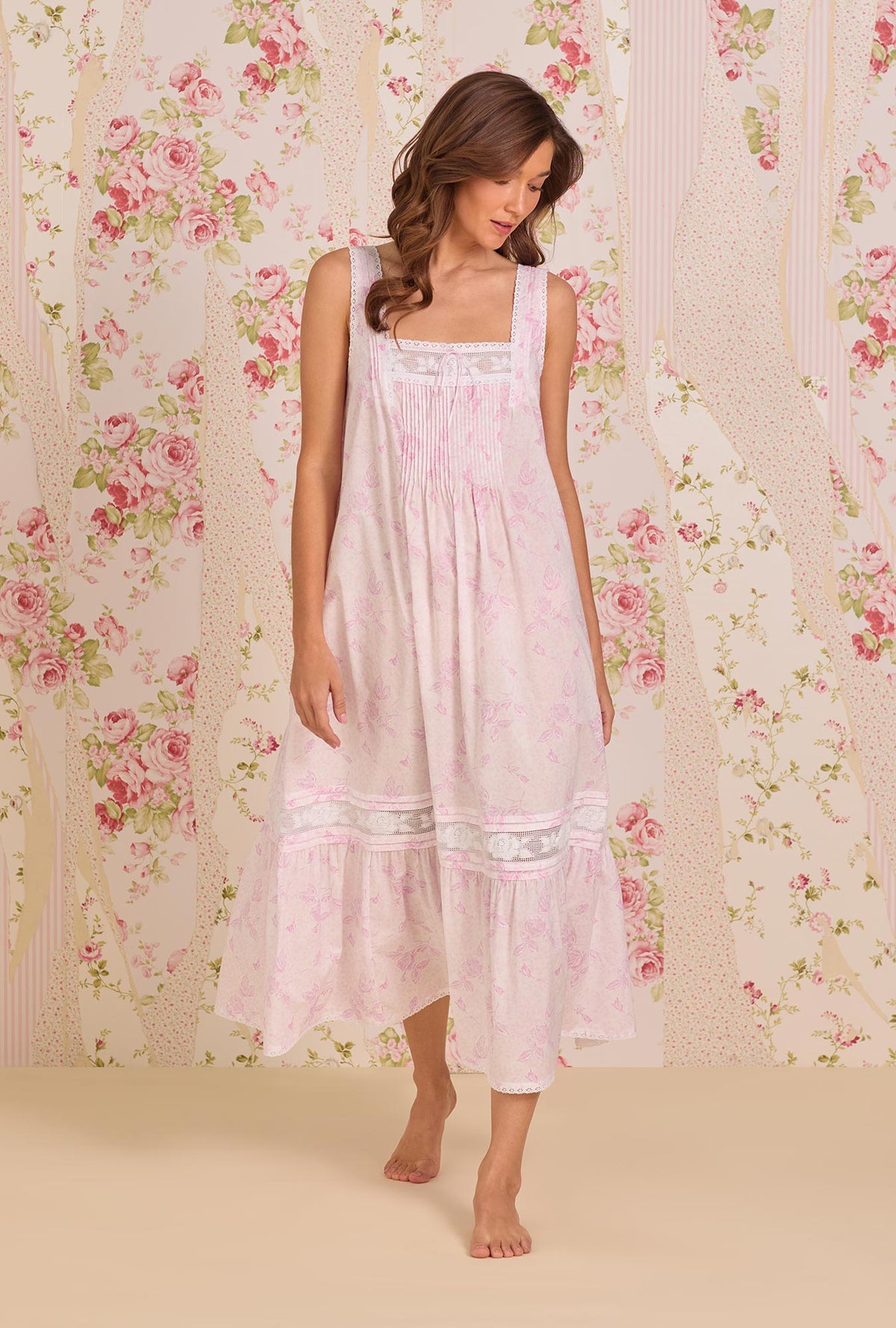 A Lady Wearing The "Adrianna" Blush Rose Cotton Lawn Ballet Nightgown facing front in a walking pose, looking down