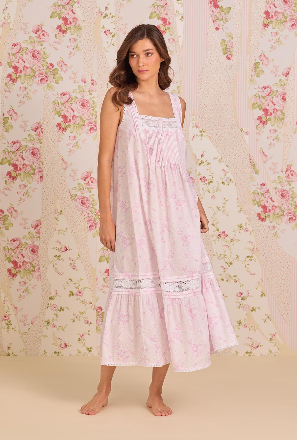 A Lady Wearing The "Adrianna" Blush Rose Cotton Lawn Ballet Nightgown facing front in a side angle pose looking to the side
