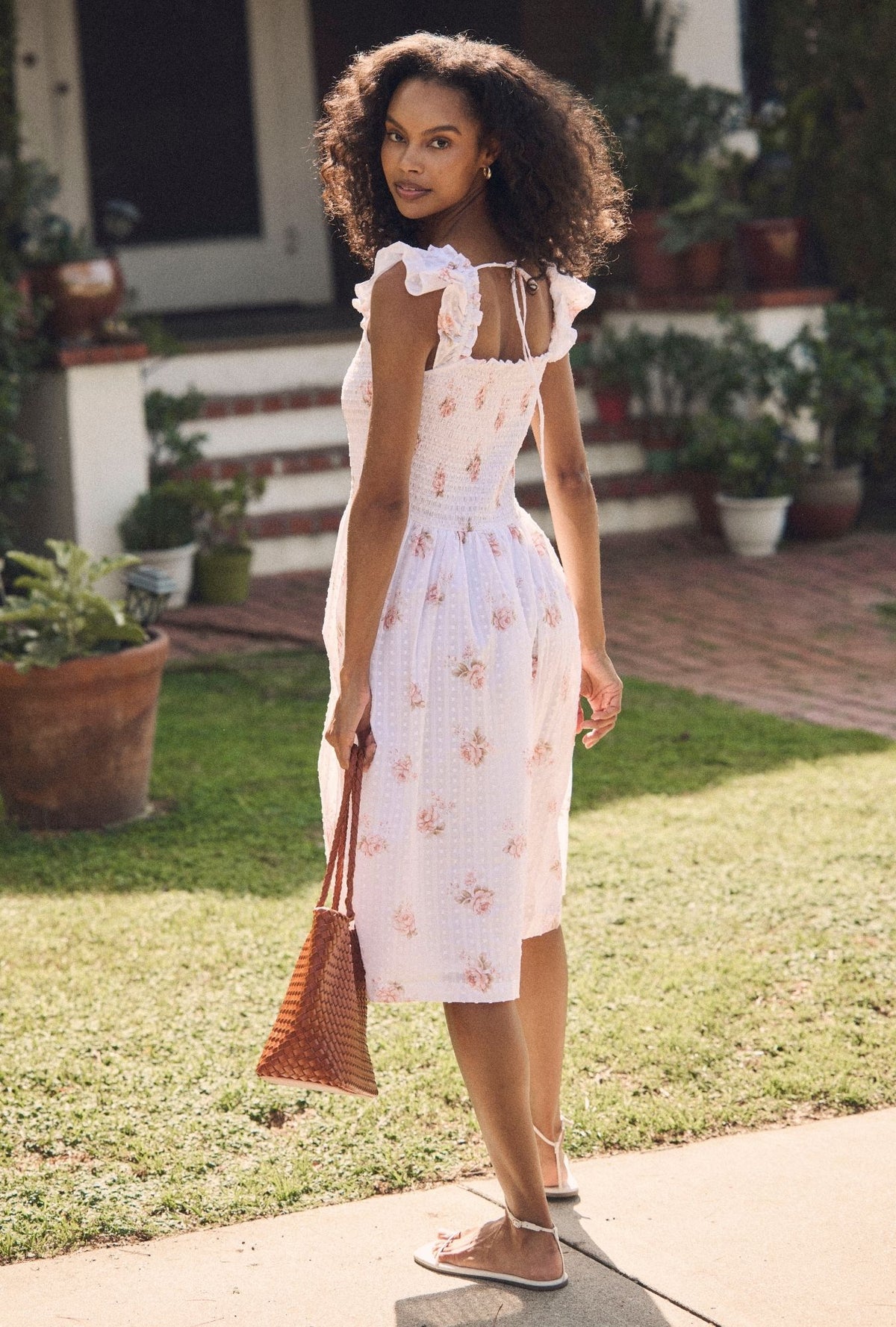 A lady wearing the "Ada" Venice Rose Cotton Swiss Dot Midi Dress back view