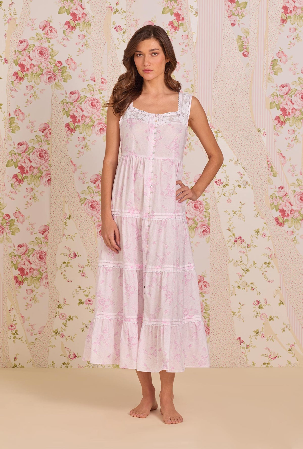 A Lady Wearing The "Monica" Blush Rose Cotton Lawn Ballet Nightgown facing front with one hand placed on her waist