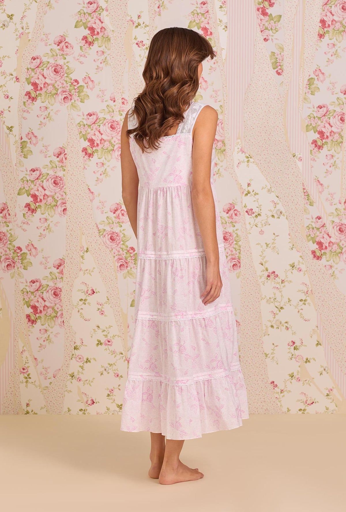 A Lady Wearing The "Monica" Blush Rose Cotton Lawn Ballet Nightgown posing back view of the dress