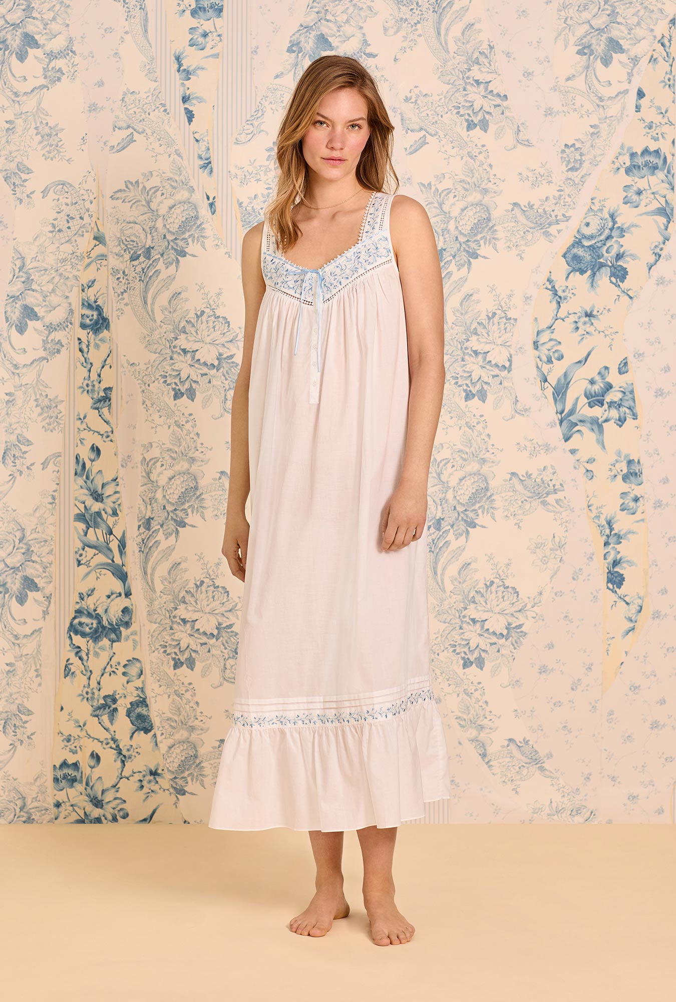 A lady wearing The "Eileen" Iconic White Cornflower Embroidery Cotton Lawn Ballet Nightgown
