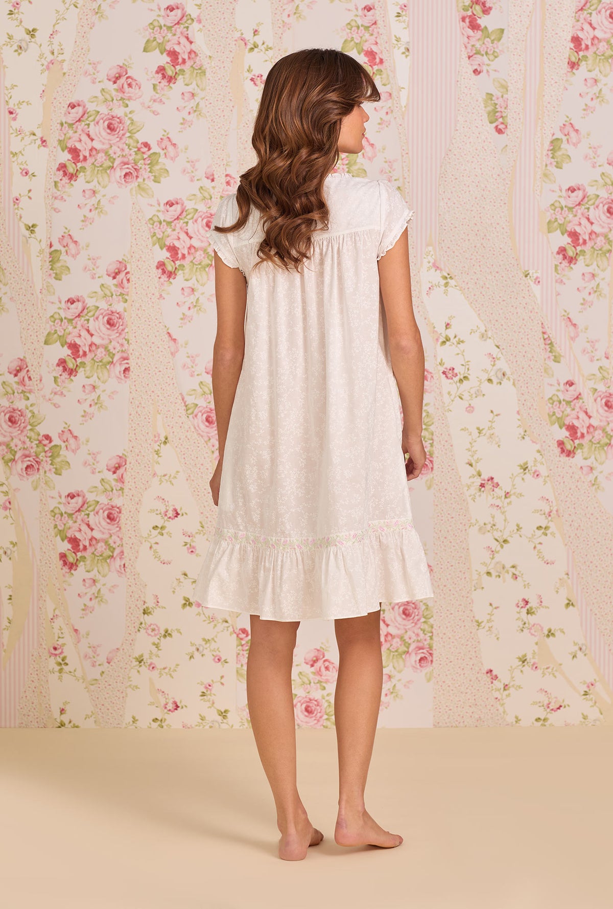 A Lady Wearing Shadow Floral Cotton Lawn Short Button Front Robe posing back view of the dress