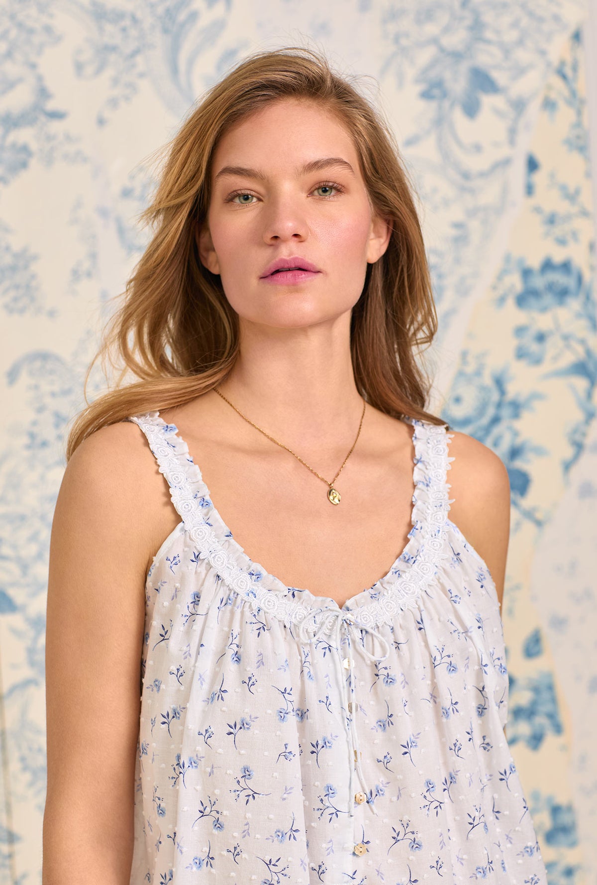 A lady wearing The &quot;Rosalie&quot; Navy Floral Swiss Dot Cami Pajama Set