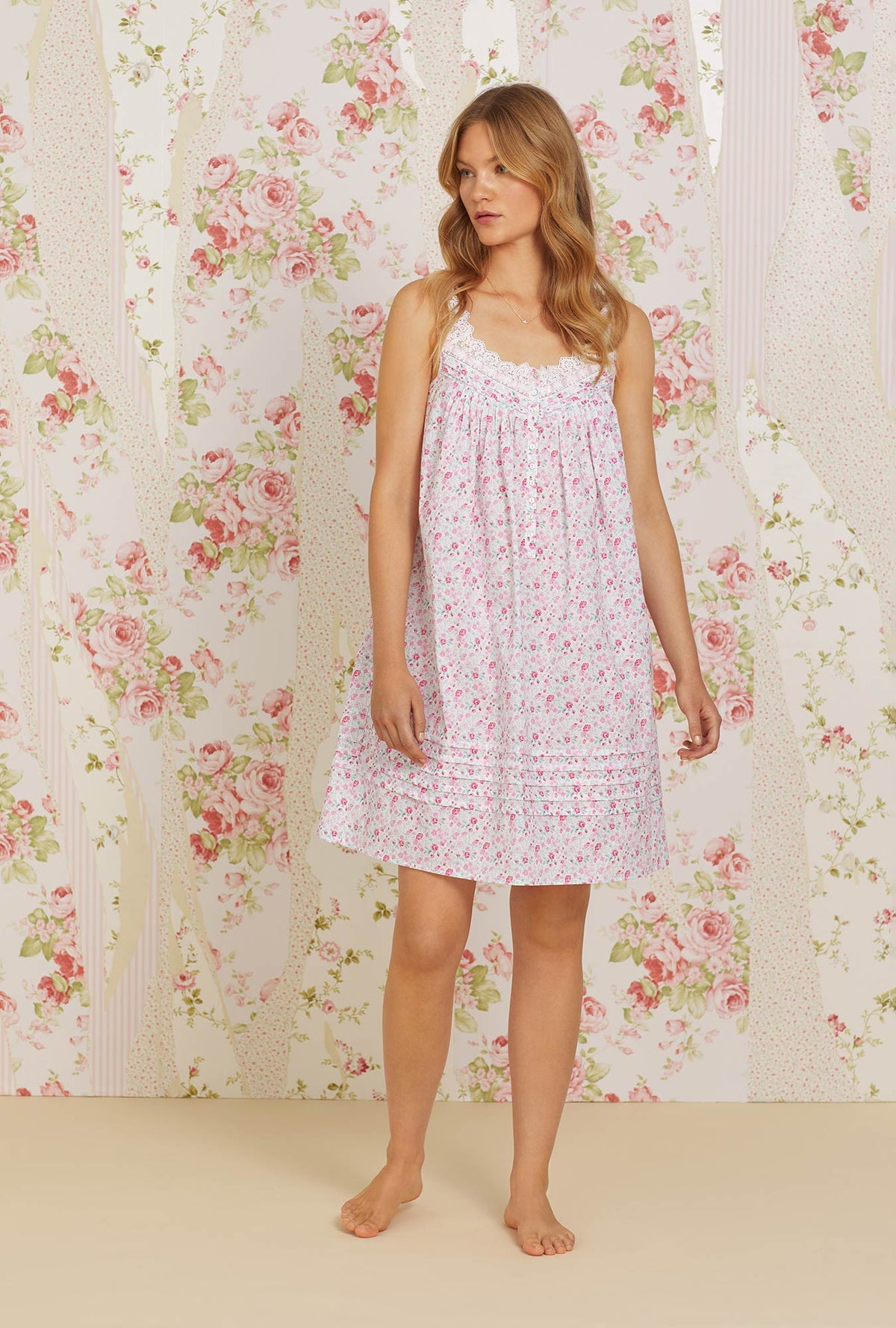 A lady wearing pink sleeveless eileen cotton chemise with secret garden floral print.