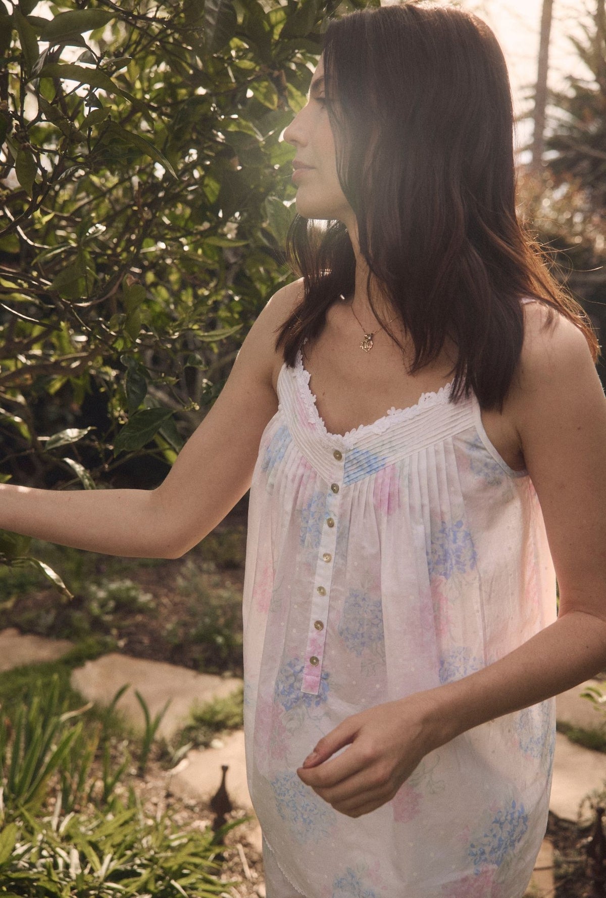 A lady wearing Hydrangea Blossom Cotton Lawn Capri Pajama  looking side in the garden