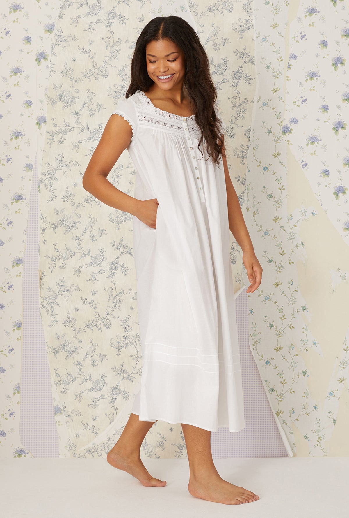 A lady wearing plus size Heirloom Dream Cap Sleeve Nightgown in a side angle view