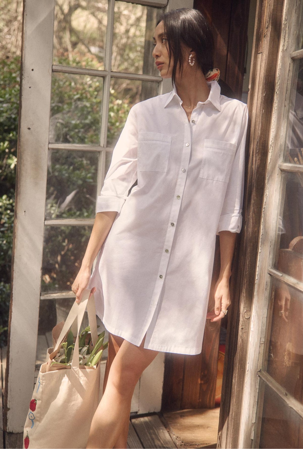 A lady wearing The &quot;Dylan&quot; Iconic White Poplin Short Shirt Dress