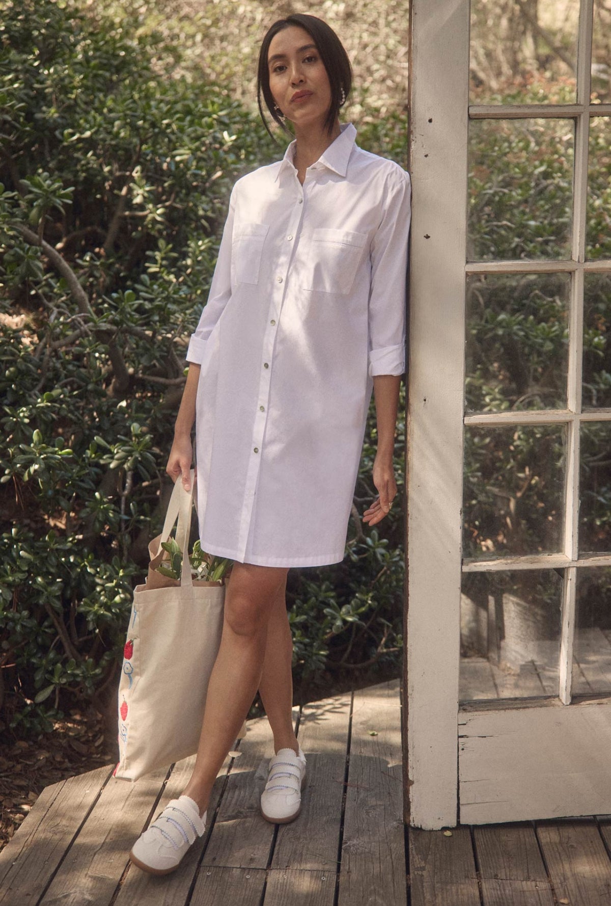A lady wearing The &quot;Dylan&quot; Iconic White Poplin Short Shirt Dress