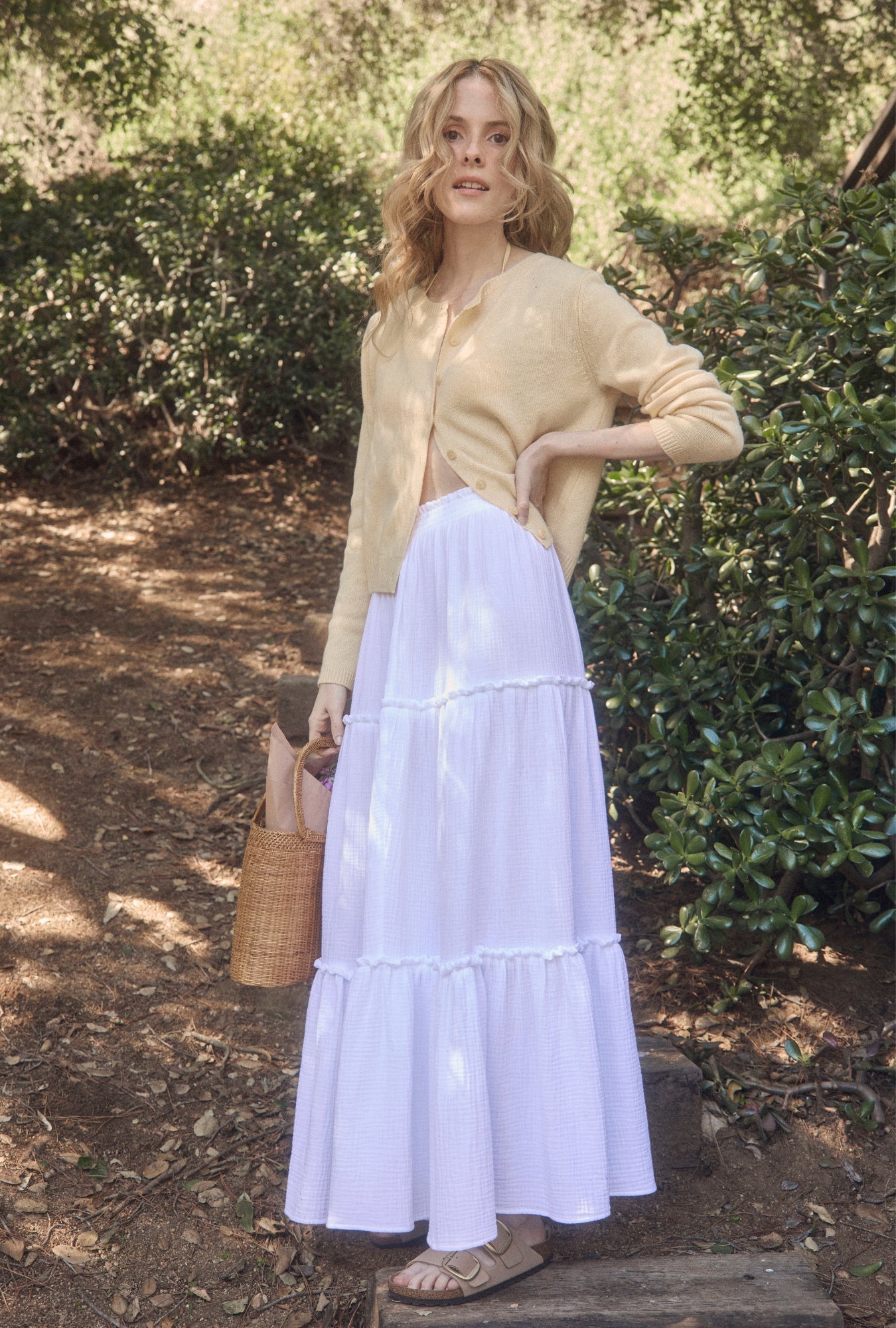 A lady wearing The "Marina" White Crinkle Gauze Maxi Skirt