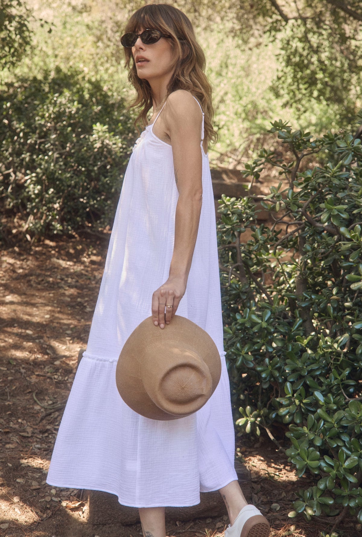 A lady wearing The &quot;Aurora&quot; White Crinkle Gauze Perfect Sundress