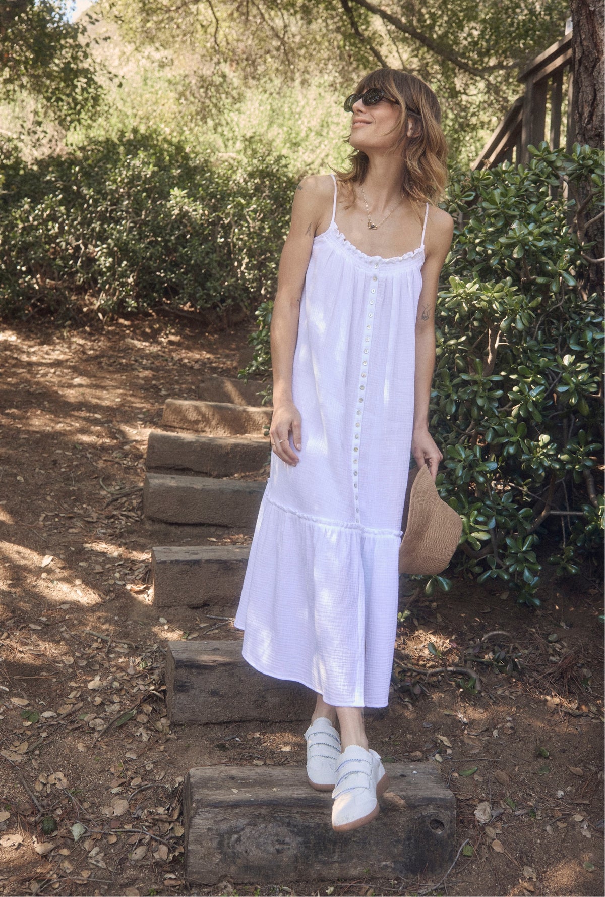A lady wearing The &quot;Aurora&quot; White Crinkle Gauze Perfect Sundress