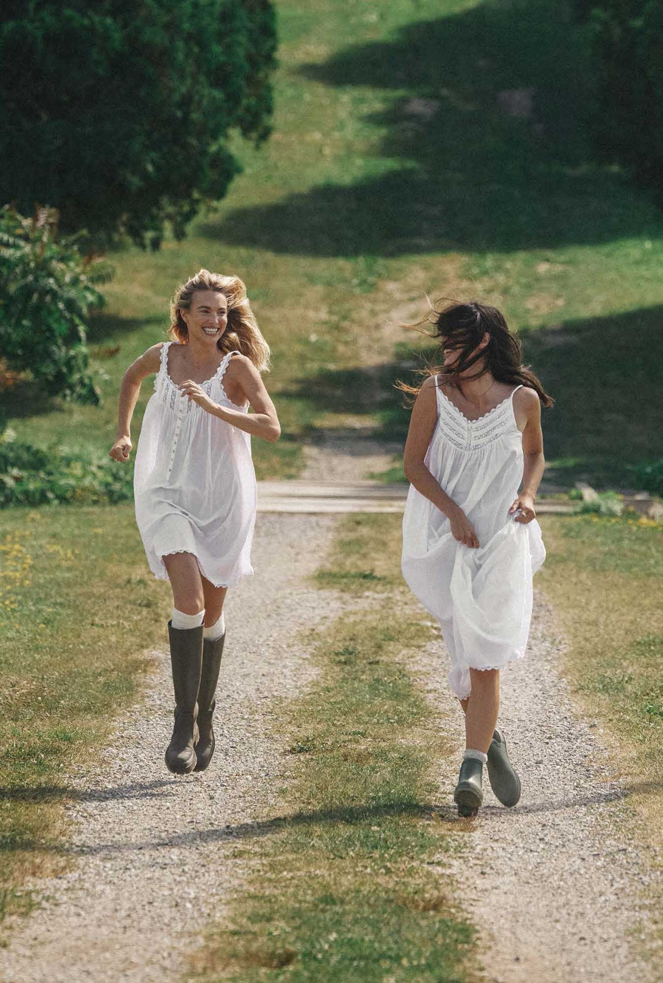 Two ladies wearing white chemise