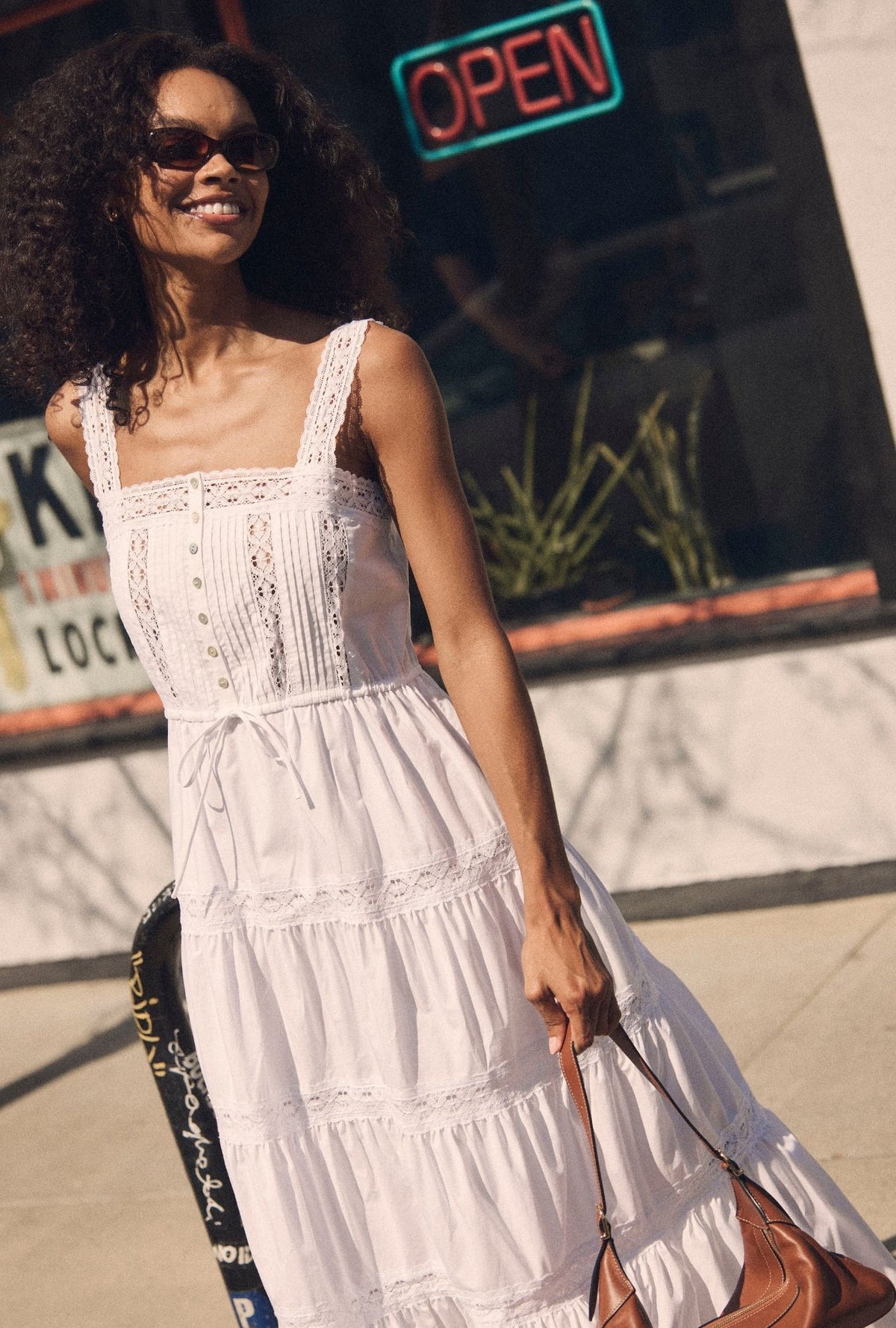 A lady wearing The "Elise" Soft White Cotton Maxi Dress closer look looking right side