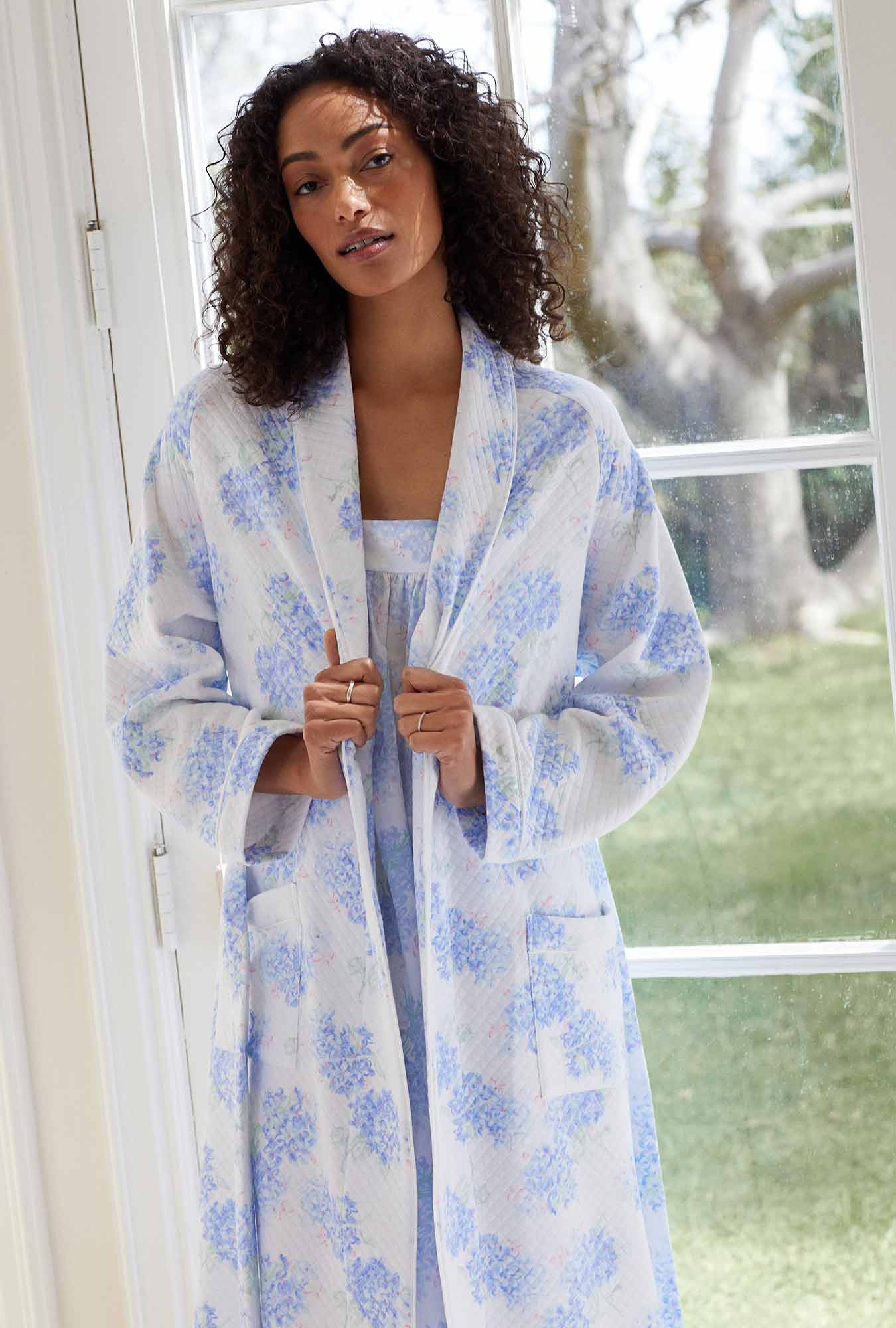 A lady wearing white robe with blur floral print