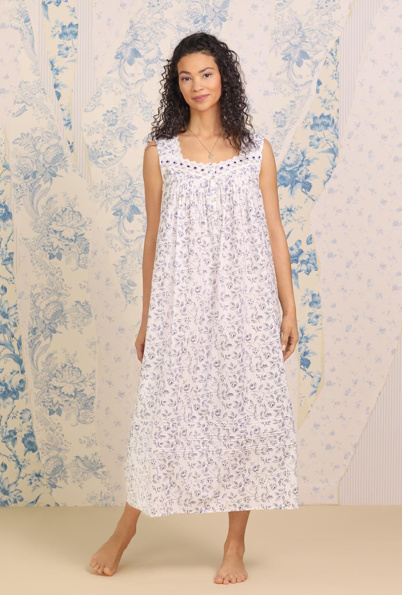 A lady wearing white sleeveless "Eileen" Cotton Nightgown with Marine Rose Floral print