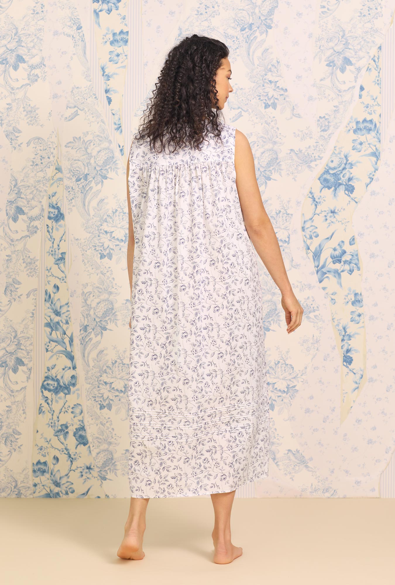 A lady wearing white sleeveless "Eileen" Cotton Nightgown with Marine Rose Floral print