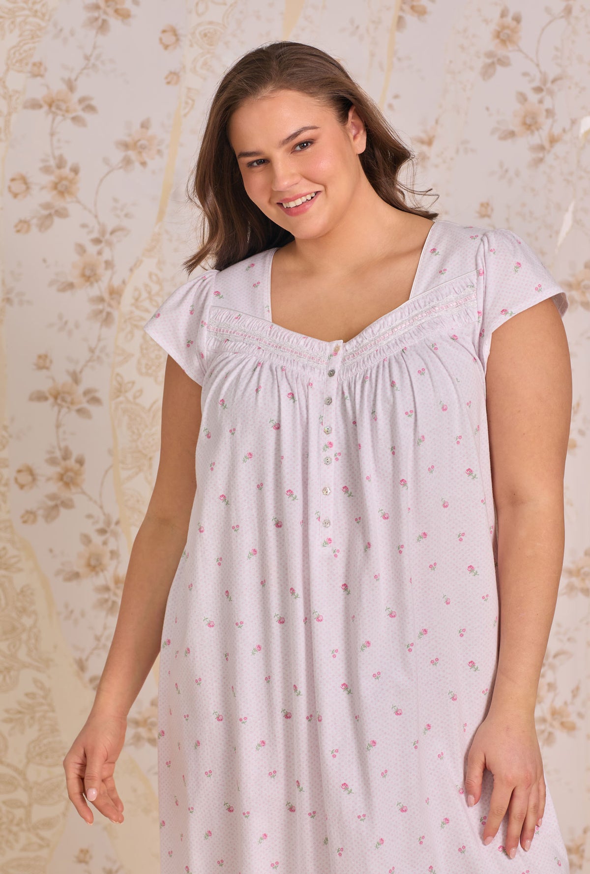 A Lady Wearing Plus Size Petite Dot Cotton Knit Cap Sleeve Ballet Nightgown facing front in a half close shot with a smile on her face
