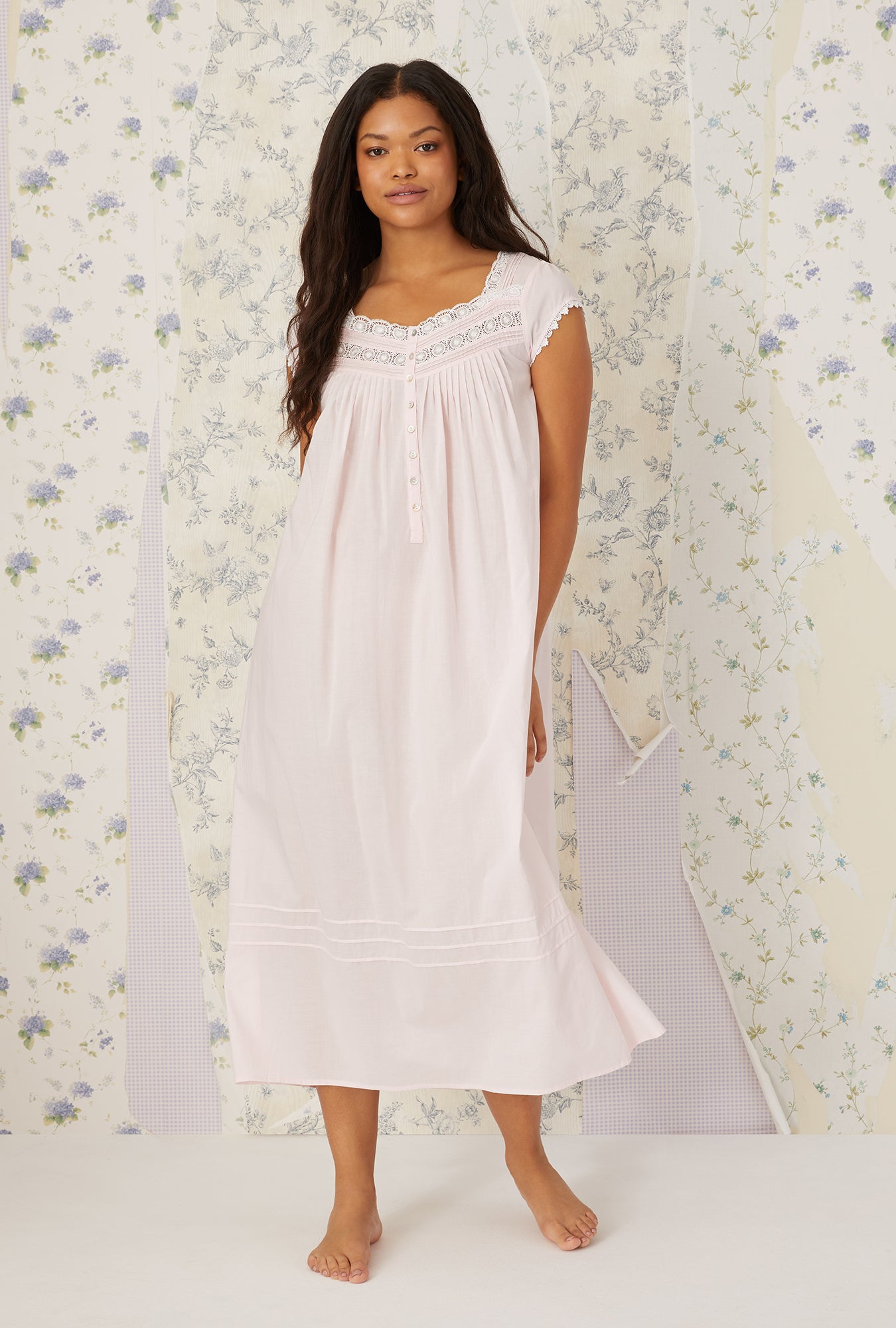 A lady wearing a white cap sleeve gown.