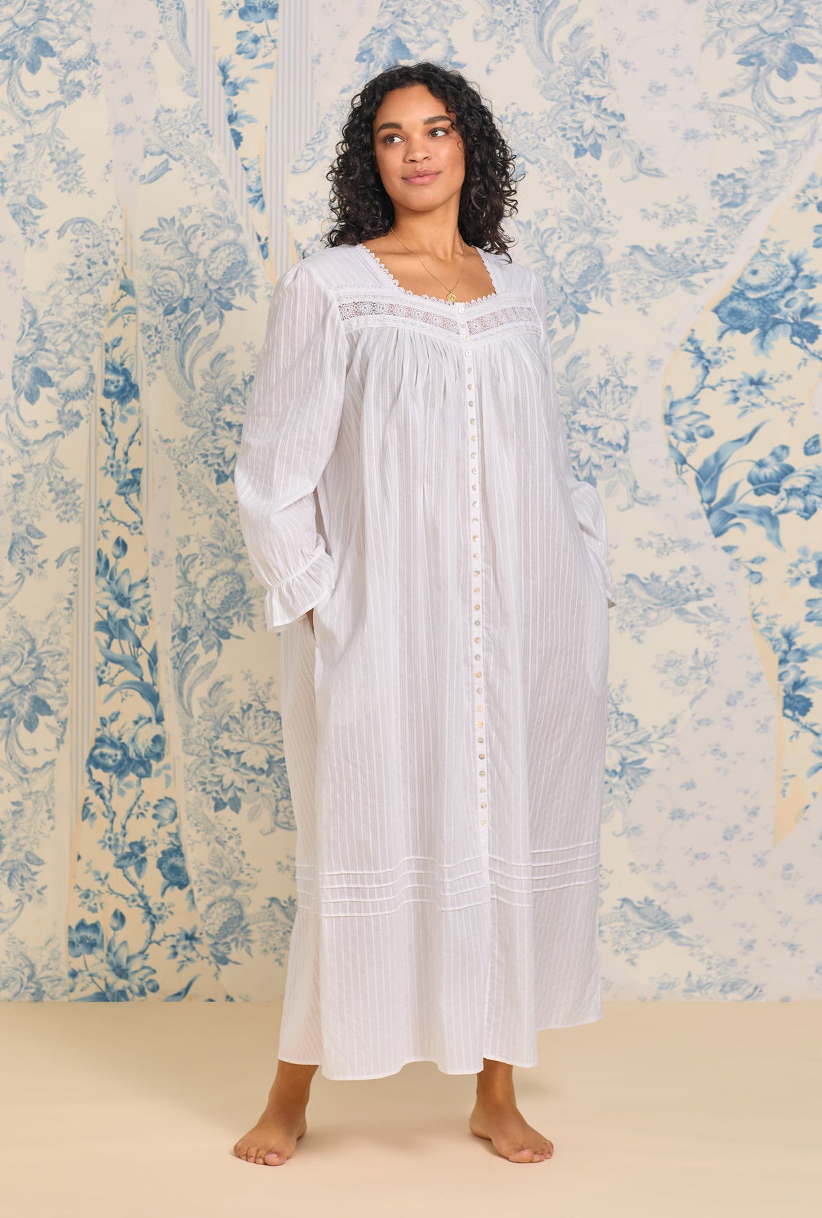 A lady wearing a pink dobby stripe long sleeve button front robe.