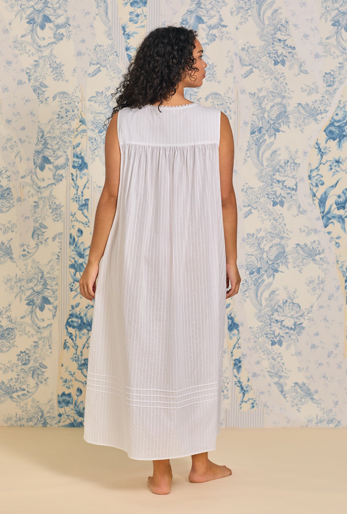 A lady wearing Dobby Stripe White Gown