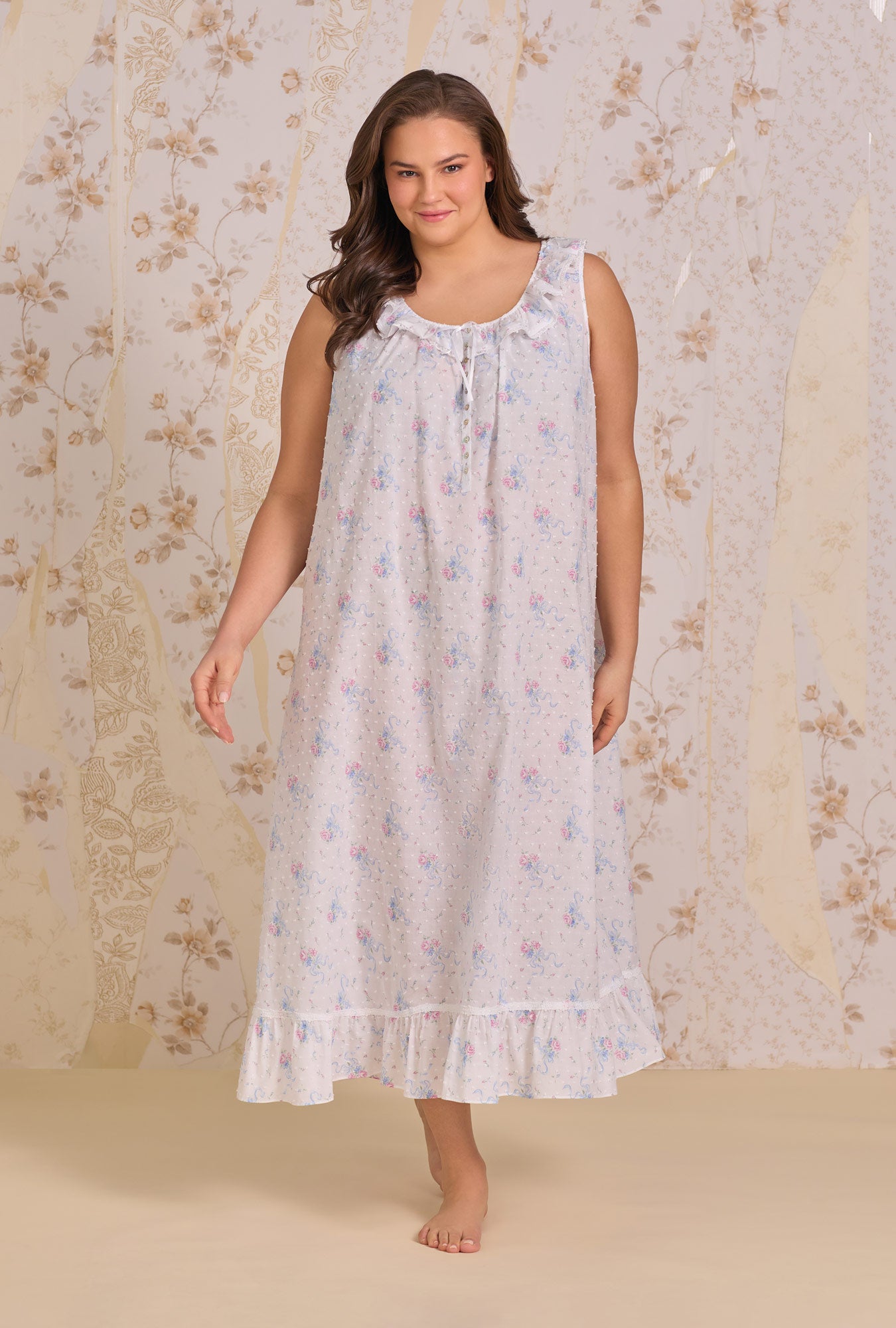 A lady wearing The "Rosalie" Whispering Ribbons Cotton Swiss Dot Ballet Nightgown near a window