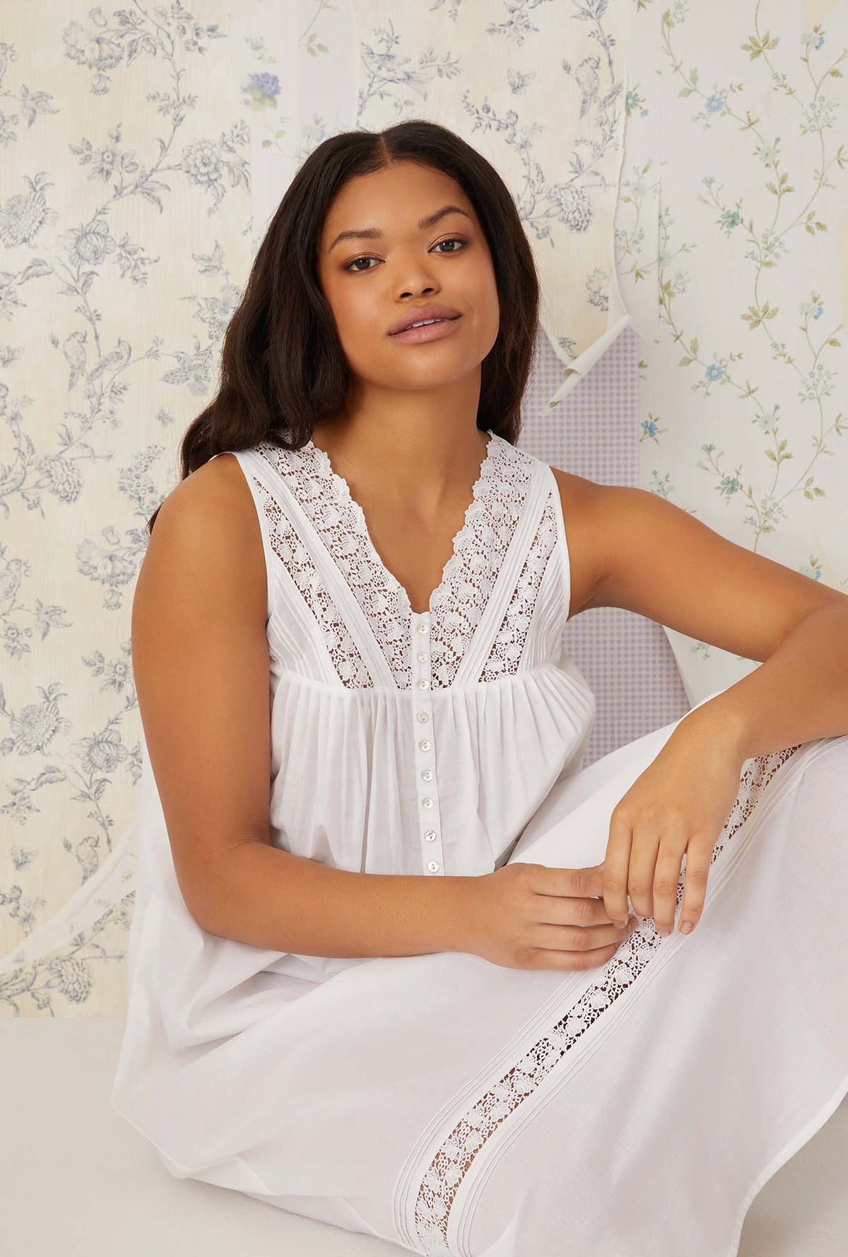 A lady wearing white sleeveless portofino ballet nightgown.