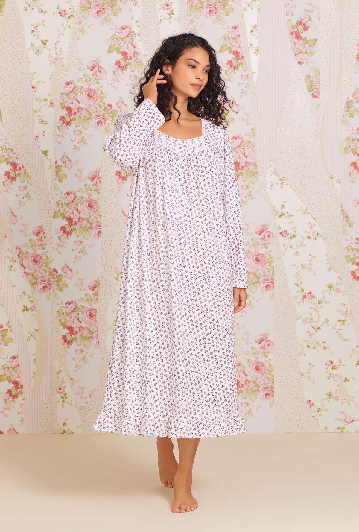 A lady wearing white long sleeve jersey cotton knit  long nightgown with holiday berries peached print.