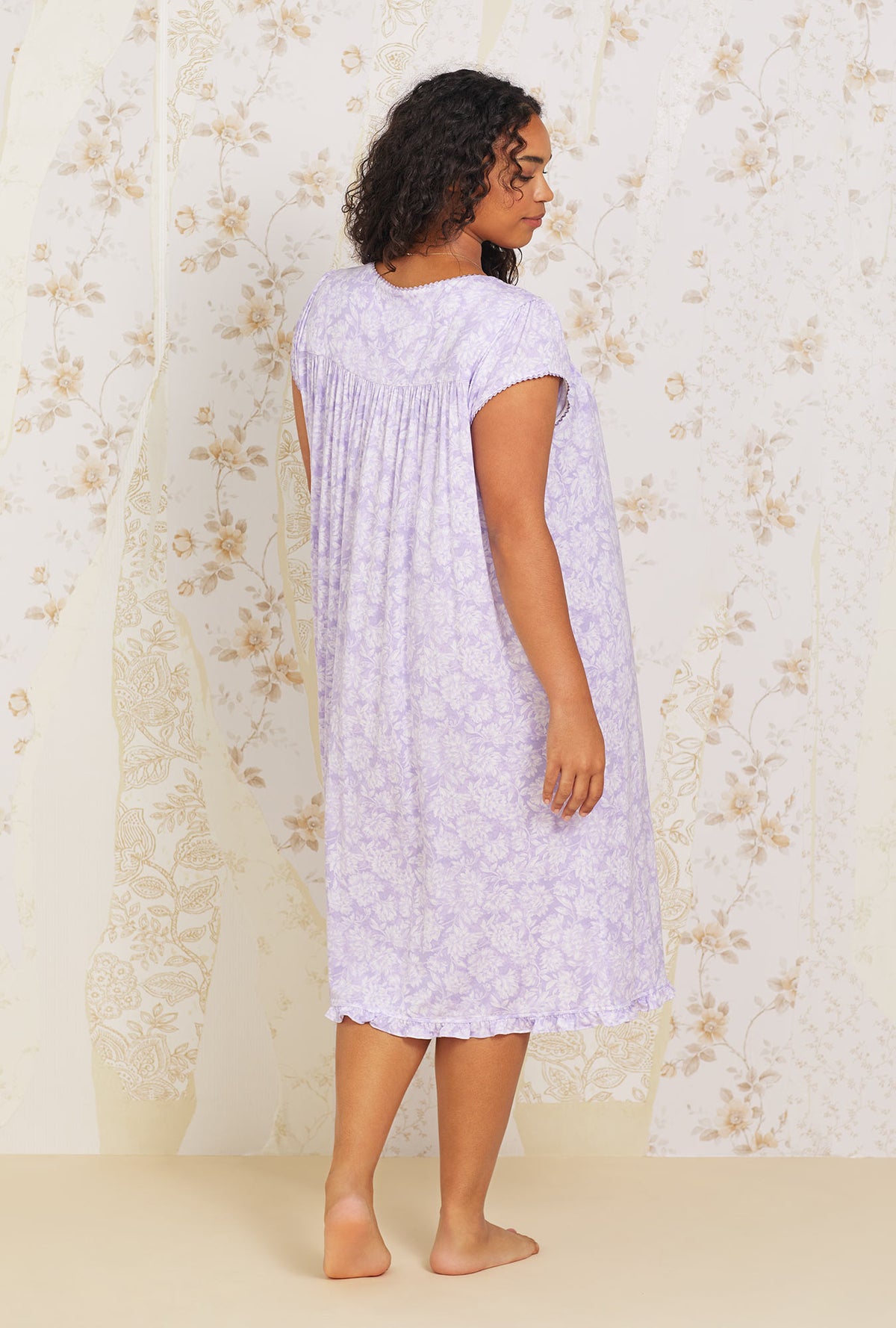 A lady wearing  plus size purple short sleeve Floral Knit Waltz Nightgown with Lilac Dream print