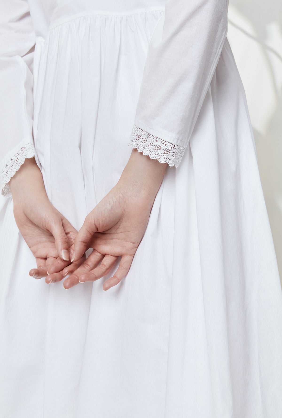 A lady wearing white victorian dreams robe.