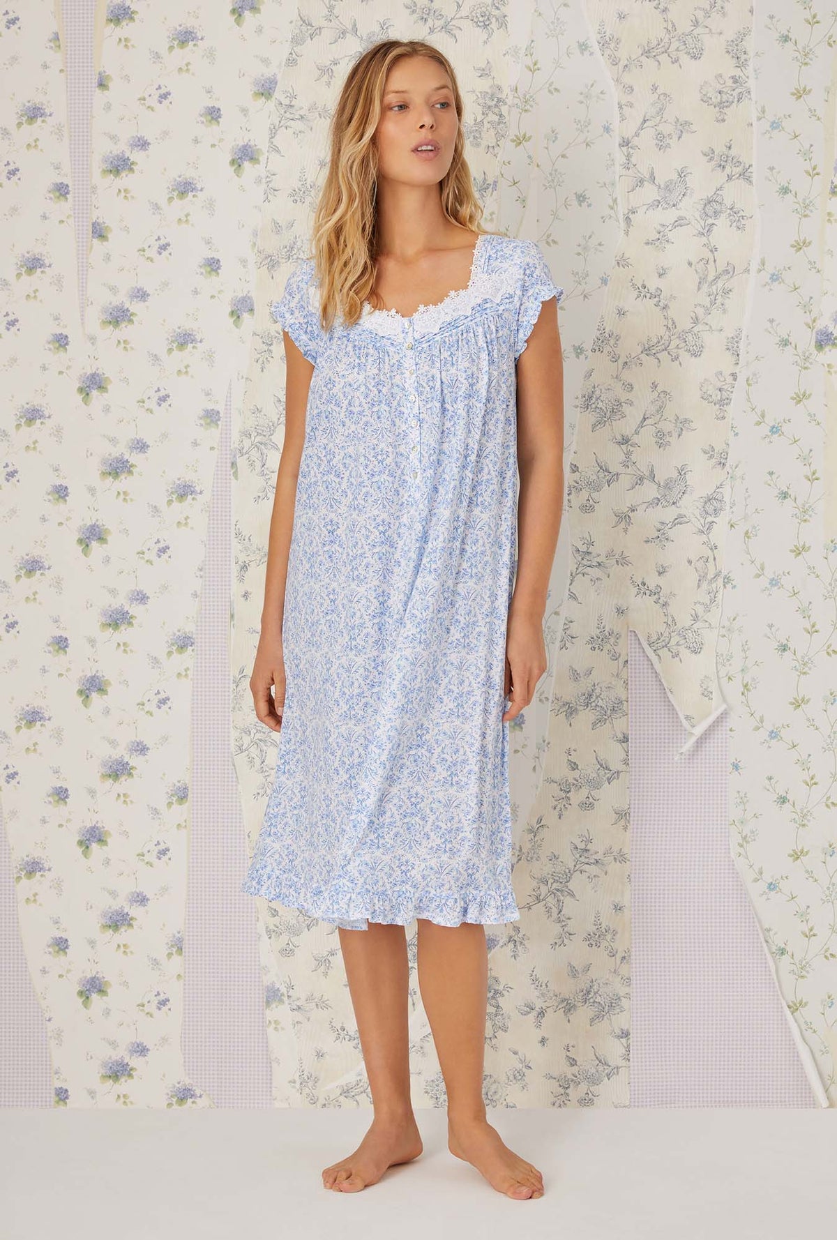 A lady wearing cap sleeve blue tapestry knit waltz nightgown.
