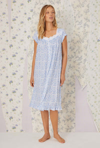 A lady wearing cap sleeve blue tapestry knit waltz nightgown.