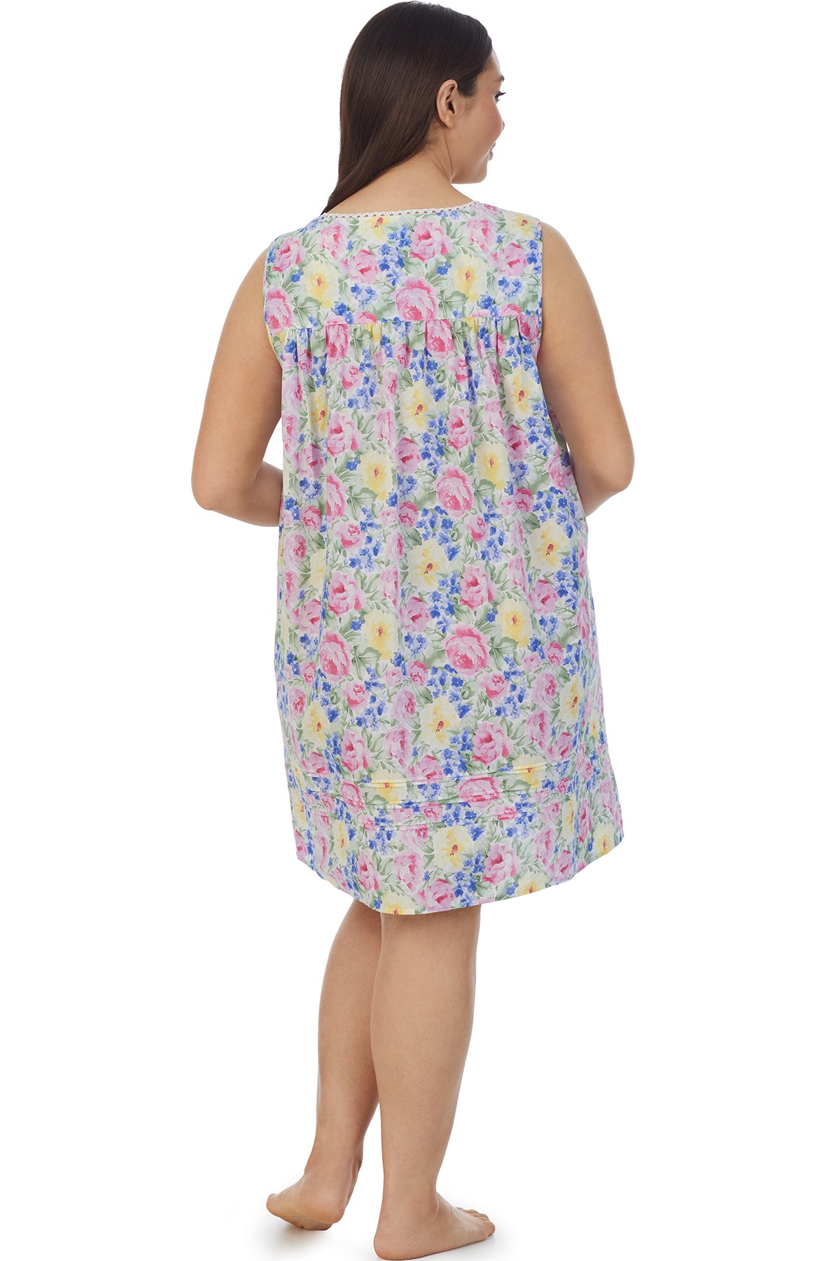 A lady wearing a sleeveless short chemise with multicolor ditsy floral pattern.