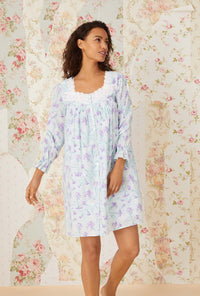 A lady wearing lavender carnations short robe.