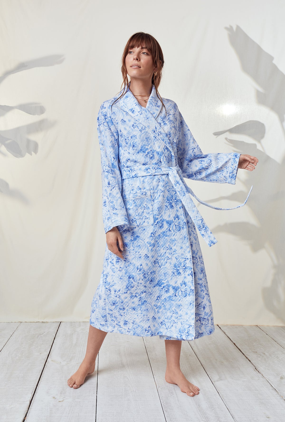 A lady wearing a blooming roses long sleeve wrap robe.