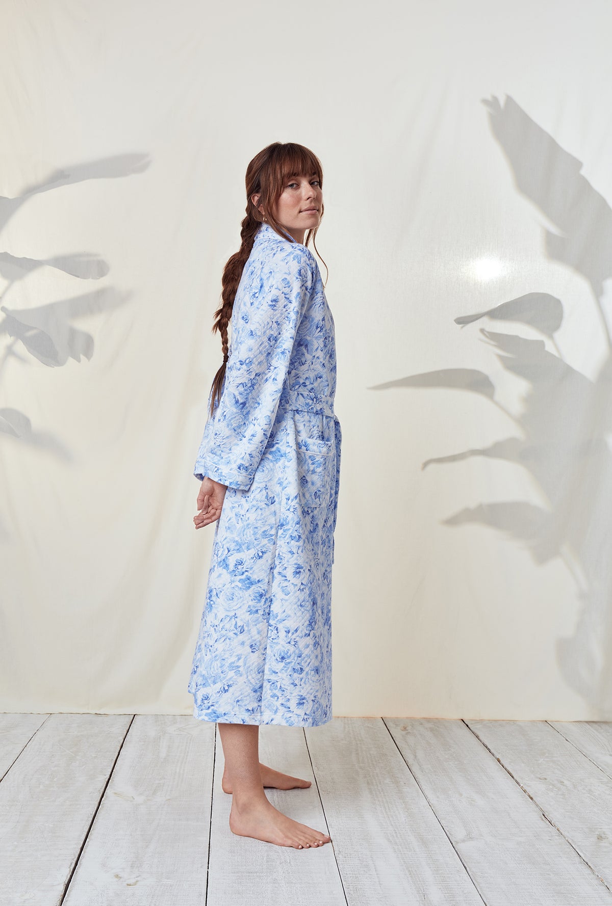 A lady wearing a blooming roses long sleeve wrap robe.
