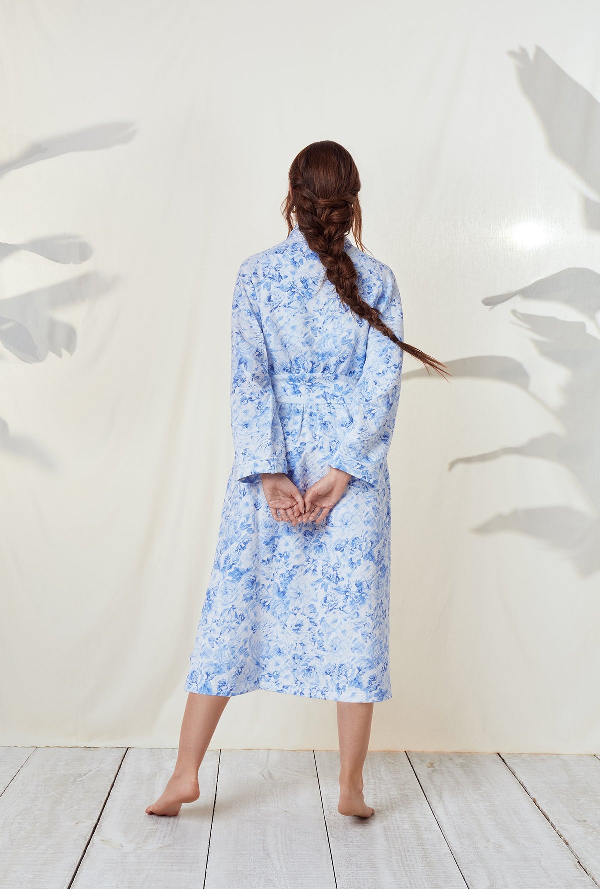 A lady wearing a blooming roses long sleeve wrap robe.