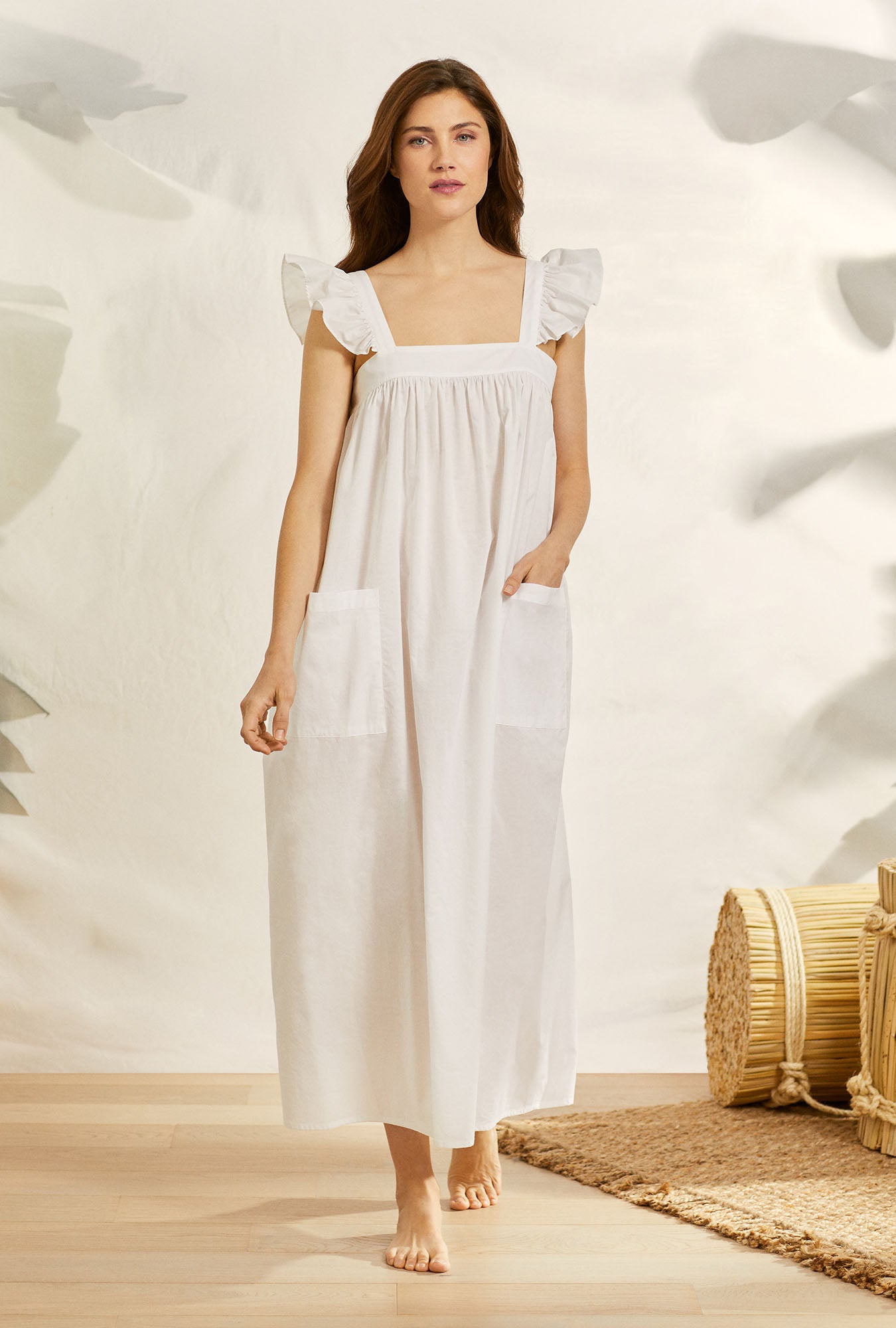 A lady wearing white butterfly sleeve soft whisper cotton angeline nightgown.