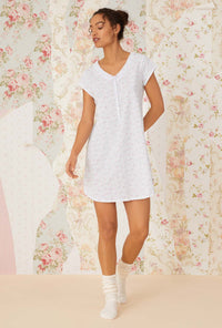 A lady wearing white cap sleeve lavender meadows cotton knit nightshirt.