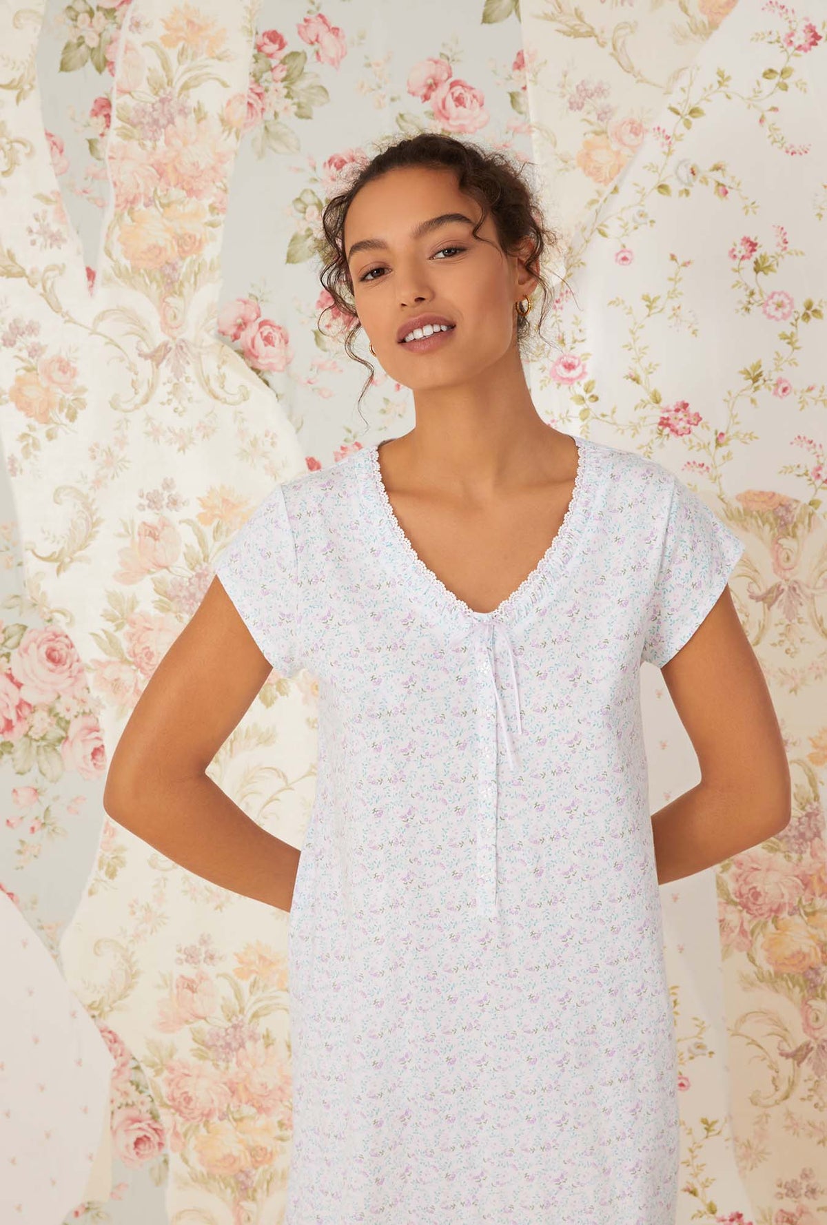 A lady wearing white cap sleeve lavender meadows cotton knit nightshirt.