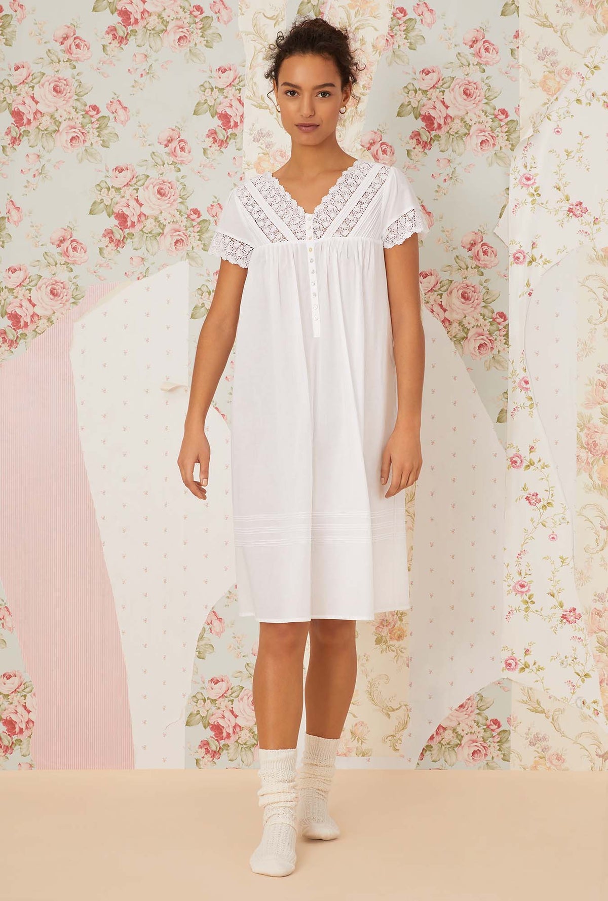 A lady wearing white short sleeve portofino waltz nightgown.