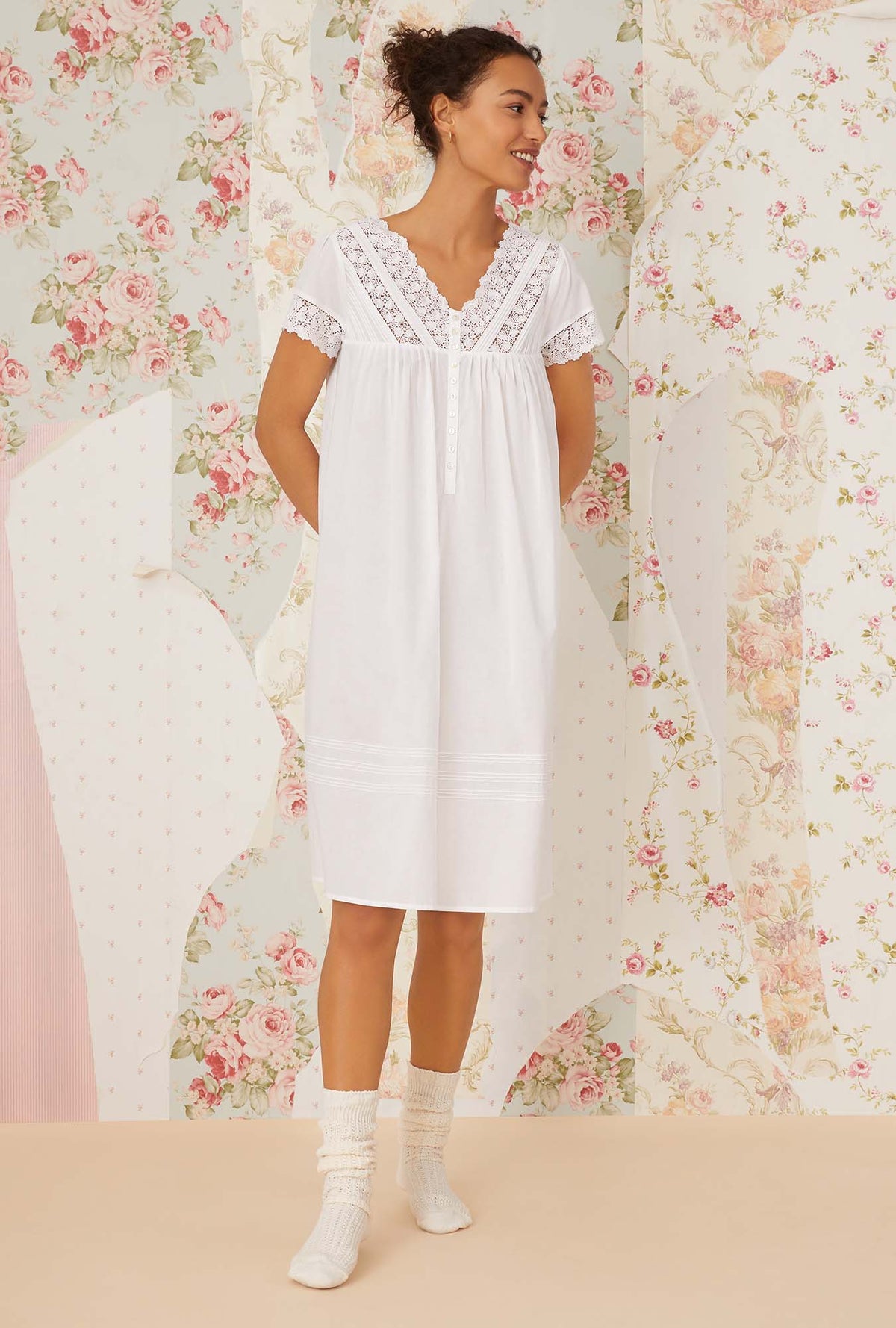 A lady wearing white short sleeve portofino waltz nightgown.