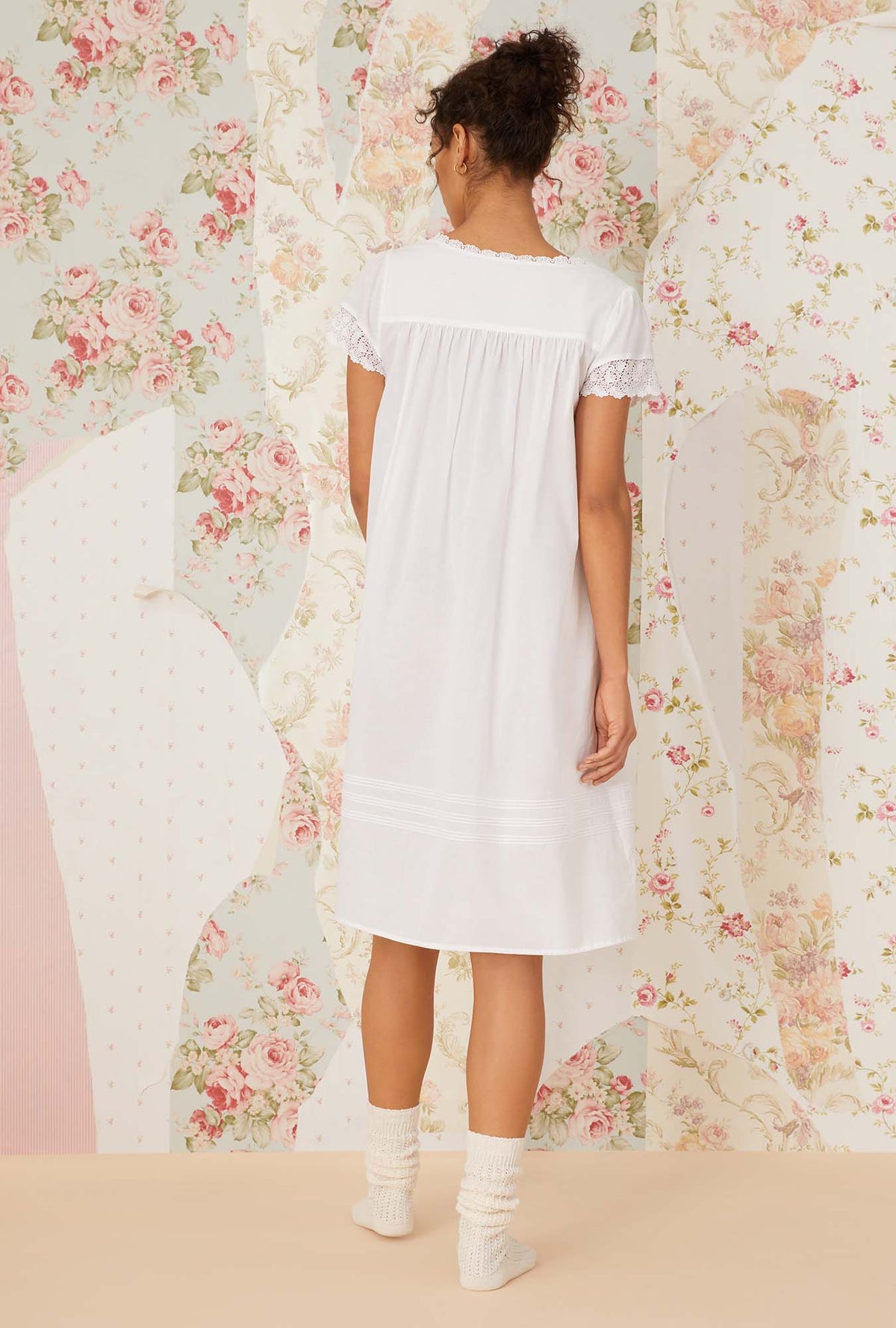 A lady wearing white short sleeve portofino waltz nightgown.